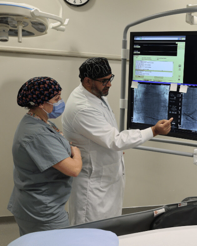 LHRP clinicians reviewing cardiac imaging in the electrophysiology lab
